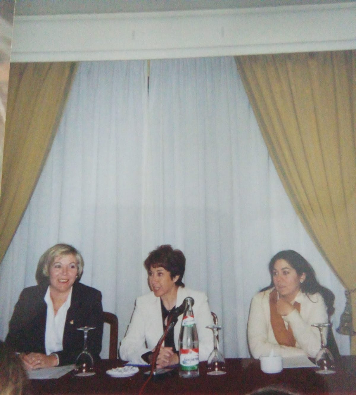 Three women participating in a conference panel